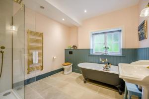 a bathroom with a tub and a sink and a toilet at 5 Bed in Church Stretton oc-t30413 in Church Stretton +58 photos
