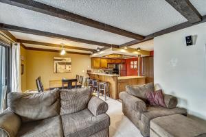 a living room with a couch and a kitchen at Longbranch 214 in Breckenridge