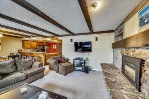 a living room with a couch and a fireplace at Longbranch 214 in Breckenridge
