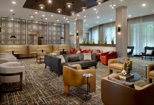 a lobby with couches and chairs and a waiting room at Courtyard by Marriott Birmingham Grandview in Birmingham