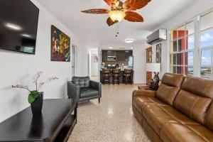 a living room with a couch and a table at 3 Villas with Stunning Views & 2 Private Pools in Luquillo