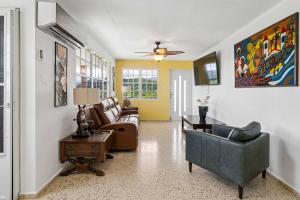 a living room with a couch and chairs and a table at 3 Villas with Stunning Views & 2 Private Pools in Luquillo +86 photos