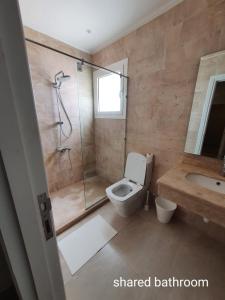 a bathroom with a shower and a toilet and a sink at Almaza bay Beach Town Chalet in Marsa Matruh