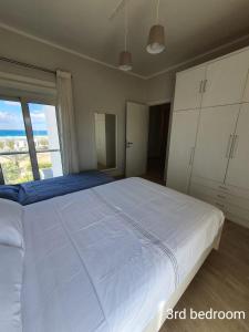 a large white bed in a bedroom with a window at Almaza bay Beach Town Chalet in Marsa Matruh +94 photos