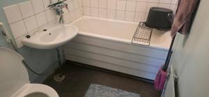a bathroom with a sink and a tub and a toilet at Pankkikallio 8 in Sorsakoski