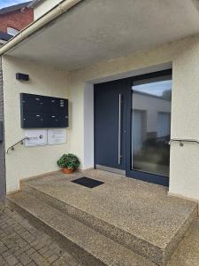 a front door of a house with a potted plant at City Apartment in Bad Arolsen