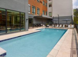 a large swimming pool in front of a building at Courtyard by Marriott Birmingham Grandview in Birmingham