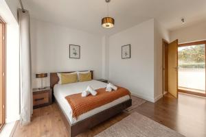 a bedroom with a bed and a large window at Vila Moleza in Vau