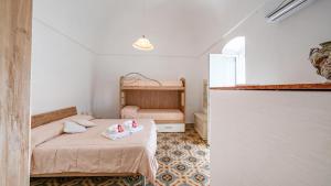 a bedroom with a bed with towels on it at Casa Cenzina by Rentbeat in Locorotondo