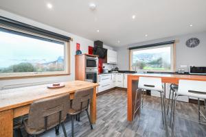 a kitchen with a table and chairs and a large window at Soundview in Lerwick