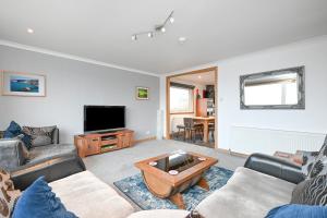 a living room with a couch and a tv at Soundview in Lerwick