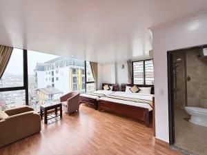 a bedroom with a bed and a bathroom with a window at Sweden SaPa Hotel in Sapa +12 photos