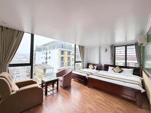 a hotel room with two beds and a large window at Sweden SaPa Hotel in Sapa