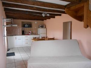 a kitchen with a white bed in a room at gite a la ferme in Milhac
