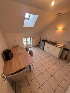 a kitchen with a wooden table in a room at Le Perchoir in Chalon-sur-Saône