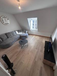 a living room with a couch and a table at Le Perchoir in Chalon-sur-Saône