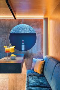 a living room with a blue couch and a table at Hey Lou Hotel Nördlingen in Nördlingen +23 photos
