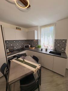 a kitchen with a table and a dining room at A due passi da Domodossola in Crevoladossola +4 photos