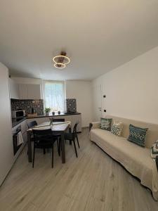 a living room with a couch and a table at A due passi da Domodossola in Crevoladossola