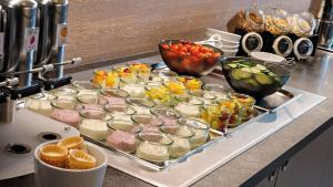 a tray filled with many different types of food on a counter at Hey Lou Hotel Monheim am Rhein in Monheim