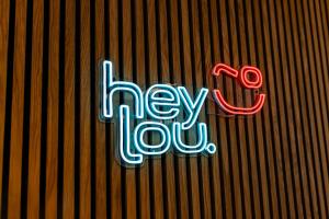 a neon sign on the side of a wall at Hey Lou Hotel Hildesheim in Hildesheim