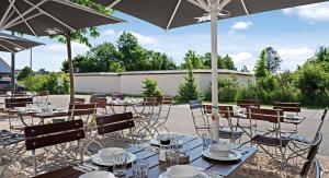 a group of tables and chairs with umbrellas at Hey Lou Hotel Piding in Piding