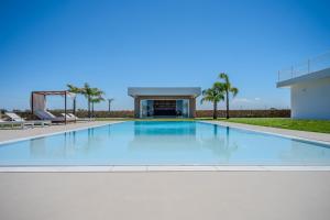 a large swimming pool in front of a building at Tenuta Bruni - Agriturismo & Pool in Squinzano