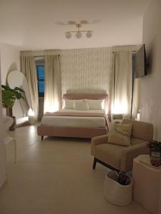 a bedroom with a bed and a couch at Al vecchio Incasato in Grottammare
