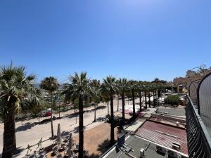 a view of a beach with palm trees at Studio Bandol Port in Bandol +6 photos