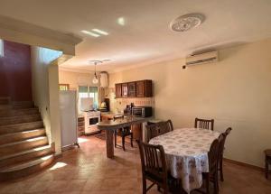 a kitchen and dining room with a table and chairs at Beautiful Duplex in secure residence with 2 pools in Sidi Bouzid