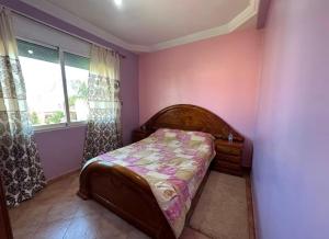 a small bedroom with a bed and a window at Beautiful Duplex in secure residence with 2 pools in Sidi Bouzid +20 photos