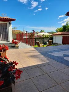 a patio with a red fence and some flowers at Askatasuna in Itxassou