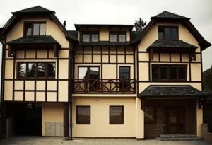 a large house with a lot of windows at Apartmán KATY in Rajecké Teplice