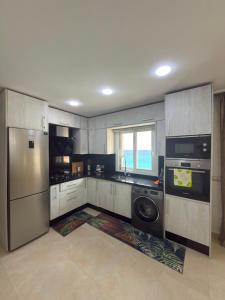 a kitchen with a refrigerator and a dishwasher at Appartement à plage Dalia in Dalia