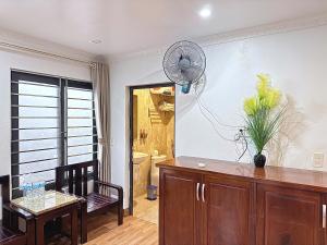 a room with a table and a fan on the wall at Sweden SaPa Hotel in Sapa