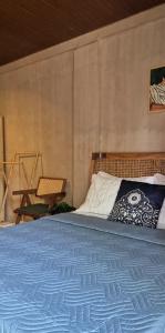 a bedroom with a large bed with a blue blanket at Casa Elia l Beach Nook Suite l Walk to Beach&Surf in San Juan