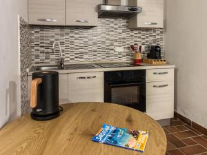 a kitchen with a wooden table with a coffee maker on it at Villa GioCar in Castelsardo
