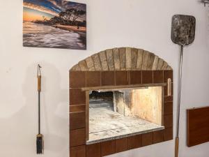 a brick fireplace on a wall with a picture on the wall at Villa GioCar in Castelsardo