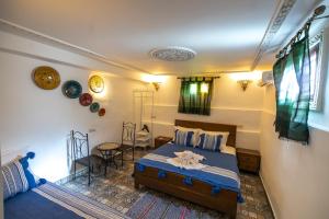 a bedroom with a bed and a table in it at Riad Lile Fes in Fez +78 photos