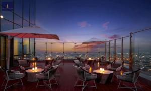 a restaurant with tables and umbrellas on a building at Landmark 81 Exclusive Panorama Residence in Ho Chi Minh City