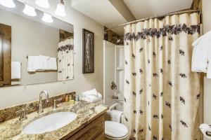 a bathroom with a sink and a shower curtain at Tannhauser 222 in Breckenridge +15 photos