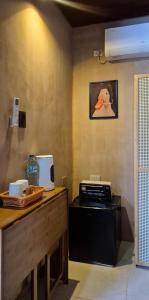 a kitchen with a counter with a stove and a picture on the wall at Casa Elia l Beach Nook Suite l Walk to Beach&Surf in San Juan