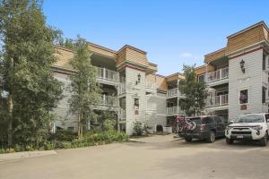 a building with cars parked in a parking lot at Tannhauser 222 in Breckenridge