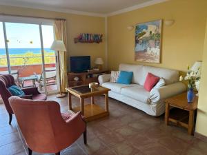 a living room with a couch and a view of the ocean at EL MIRADOR in Alaior