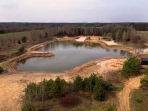 an aerial view of a pond in a field at Słoneczna Polana in Żabiczyn