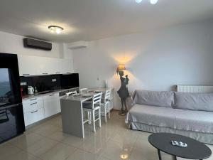 a living room with a person holding a light on the wall at Paleochora Apartments in Palaiochora