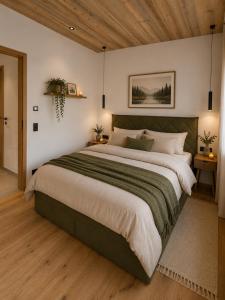 a bedroom with a large bed and a wooden ceiling at Eben Central Living in Eben im Pongau