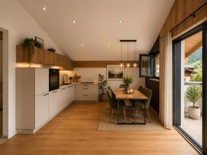 a kitchen and dining room with a table and chairs at Eben Central Living in Eben im Pongau
