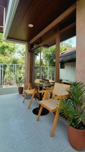 a patio with wooden tables and chairs and plants at Casa Elia l Beach Nook Suite l Walk to Beach&Surf in San Juan