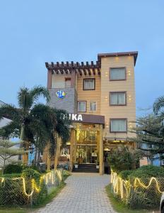 a hotel building with a walkway in front of it at Taika Hotels, 1km Away from Main Temple in Rāmeswaram